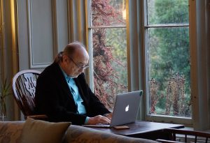 an older man working at a laptop