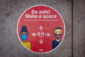 a sticker reminding people to "Be safe! Make a space" of 6 feet of social distancing