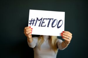 Woman holds a sign that reads #METOO
